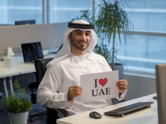 Business man representing his country at the office|