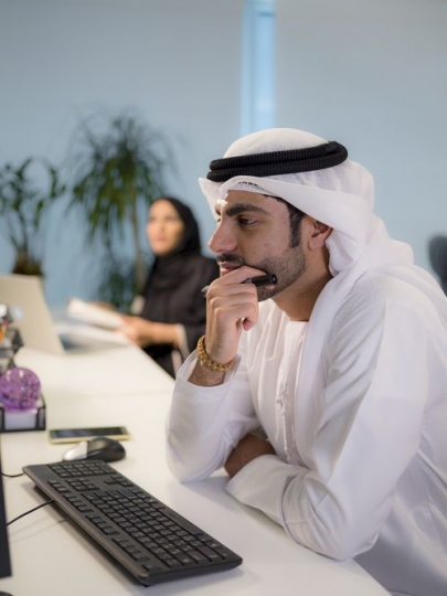 Business man sitting by his desk working |