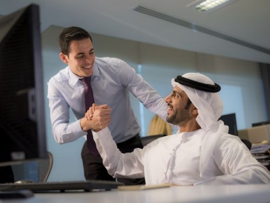 Business men shaking hands excited at the workplace|