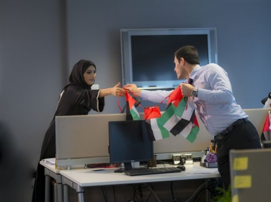 Business people decorating the office with UAE Flags |