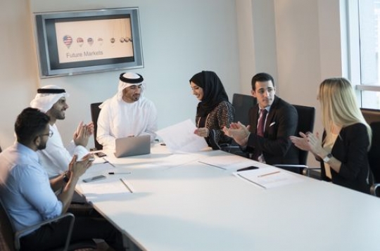 Employees clapping their hands at the end of their meeting|-