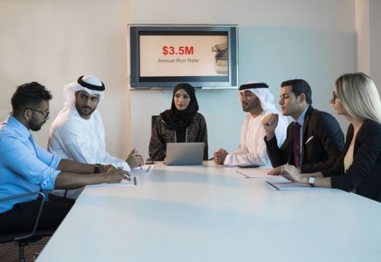 Employees having a meeting at a conference room|-