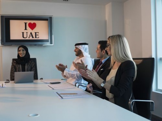 Business men and Business women clapping at the end of their meeting|-