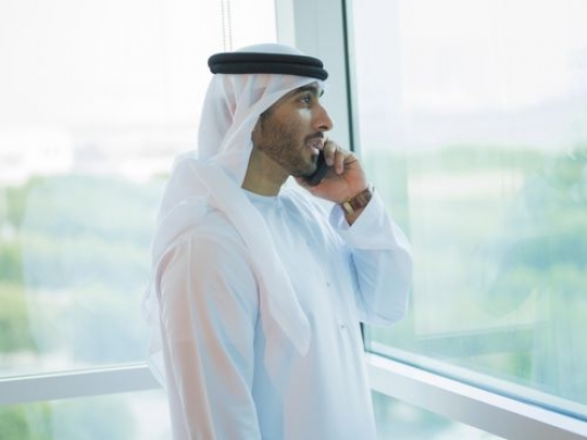 Employee making a phone call by the window|-