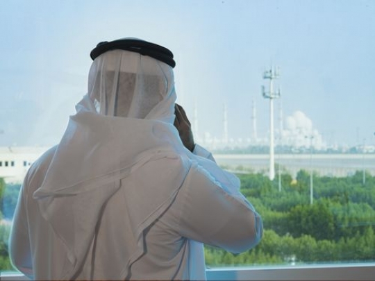 Businessman making a phone call by the window|