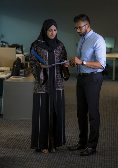 Two employees looking at file|-