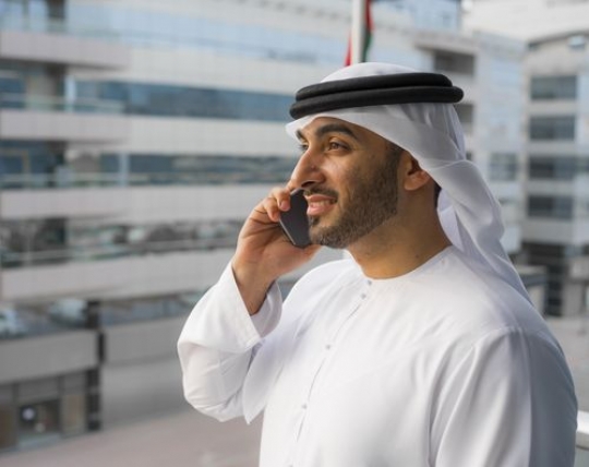 Mid-shot of a business man talking on the phone|-