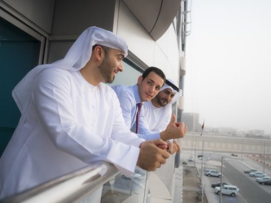 Three business men having a conversation outside|-