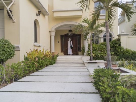 Arab man entering the house|-