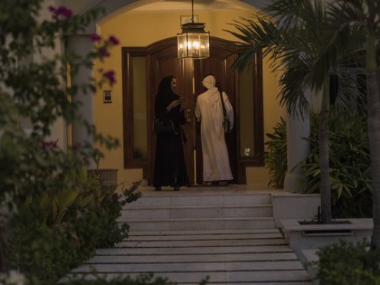 Arab man and woman entering the house|-