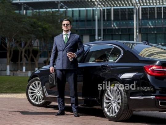 Businessman standing infront of his car |-