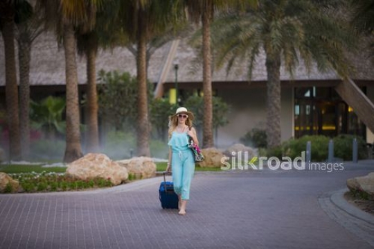 European woman walking around the resort|-