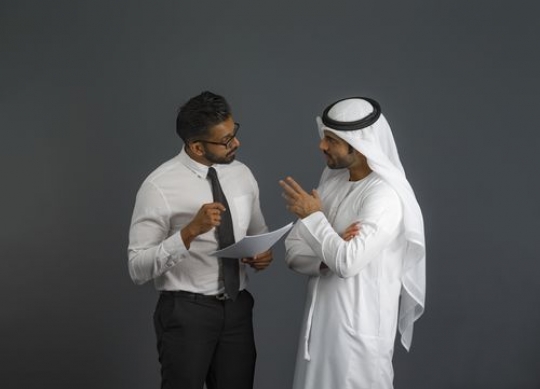 Business men standing and explaining something to each other|