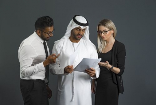 Business men and business woman standing talking to each other|