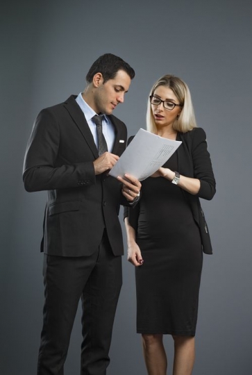 Business people standing talking to each other about the work paper|