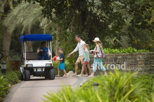 Western family walking towards club car|-