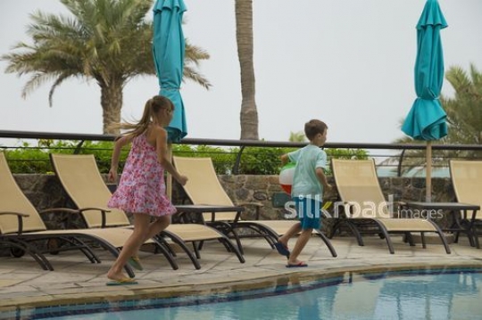 Western kids running by the pool|-