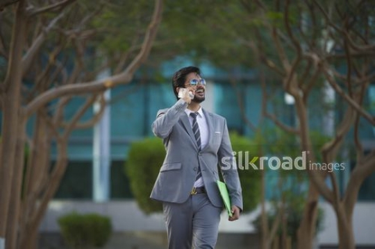 Happy Businessman talking on the phone|-