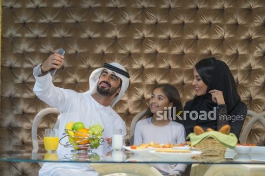 Middle Eastern family taking a selfie together|