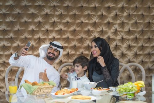 Arab family taking a photo together|-