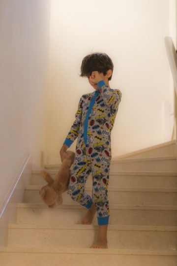 Arab boy walking down the stairs in the morning|-