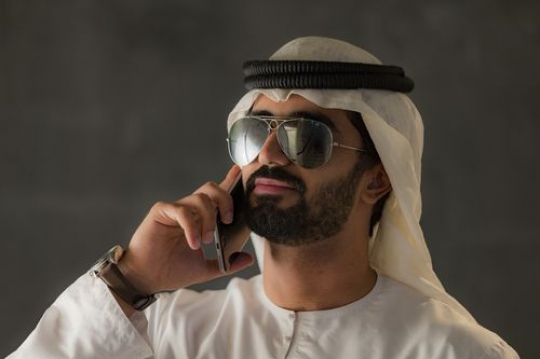 Portrait of an arab business man talking on the phone|-