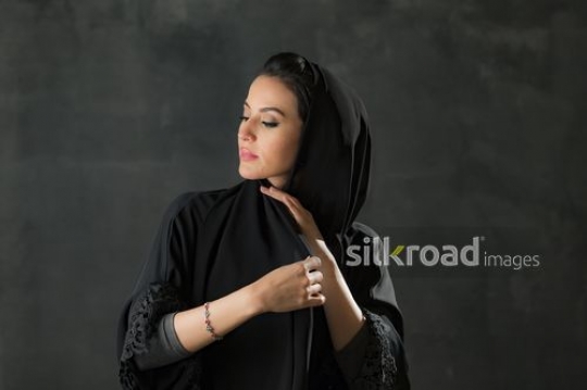 Middle Eastern woman fixing her shayla|