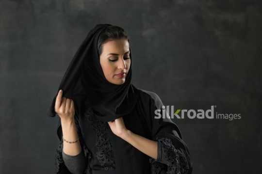 Medium shot of an Arab woman fixing her shayla|