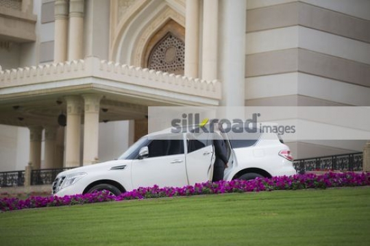Arab Businessman standing next to the car|