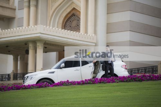 Middle Eastern Businessman closing the door of the car|