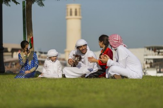 Arab teenager playing the guitar and the rest are singing along |-