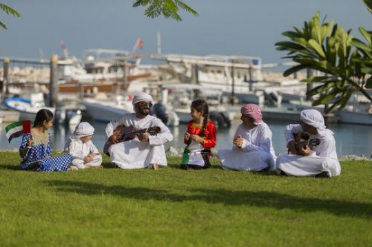 Middle eastern family and friends celebrating national day|-
