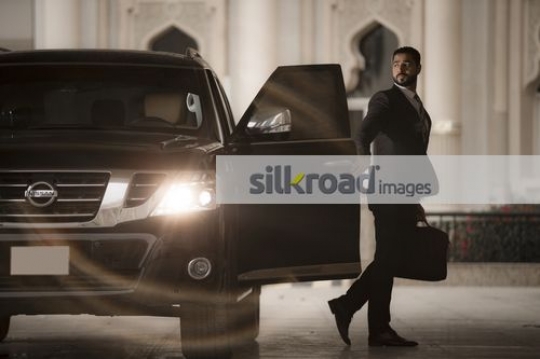 Arab Businessman closing the door of the car|