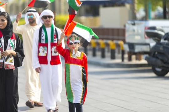 Arab girl at a parade celebrating National day|