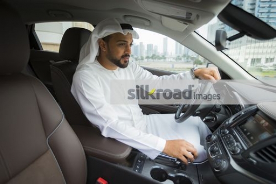 Middle Eastern Businessman sitting inside the car|