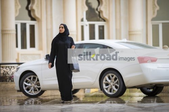 Arab Businesswoman dressed in the traditional attire walking|