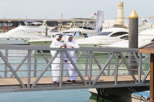 Arab men standing by the dock |