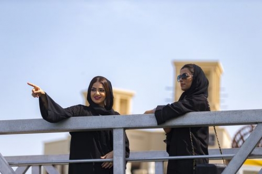 Arab women standing by the dock talking to each other|