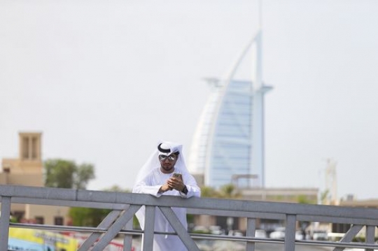 Middle eastern man standing by the dock |