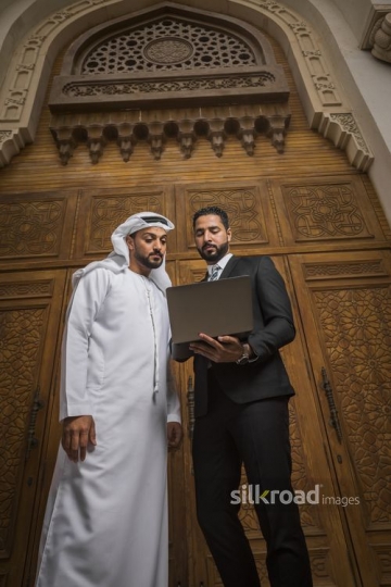 Arab Businessman standing together using the laptop|-