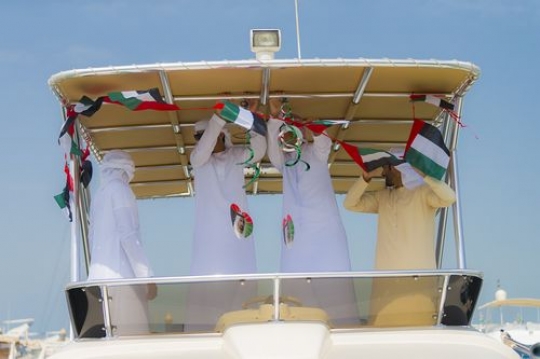 A group of men celebrating National Day while decorating the Yacht|