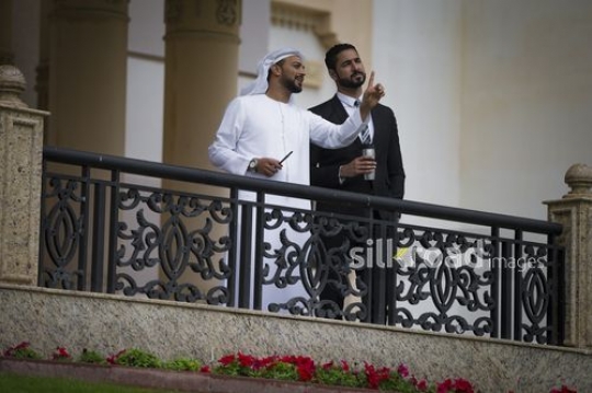 Business man pointing and talking to his colleague |-