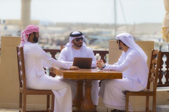 Business people sitting outside during a meeting|