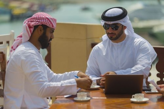 Business man handing paper to client during a meeting|