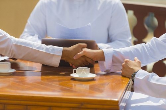 Two business men shaking hands after a meeting|