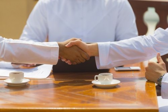Close up of business men shaking hands after a meeting|