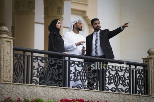 Businessmen and Businesswoman talking on the bridge together|-