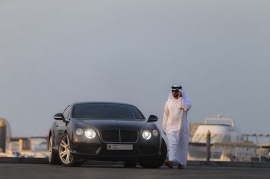 Arab man in motion walking away from his vehicle|-