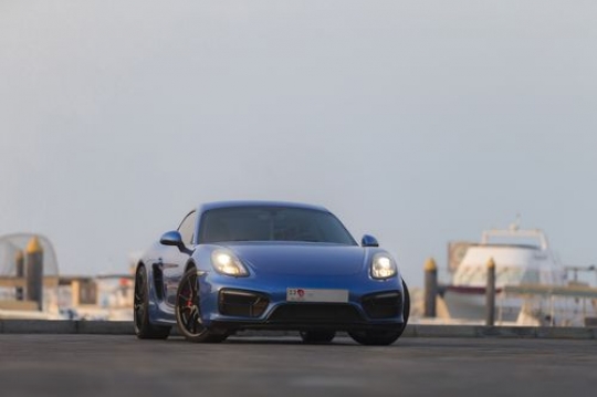 Blue colored luxury car parked|-