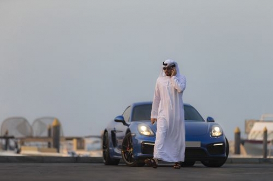 Arab man walking away from his own luxury car|-